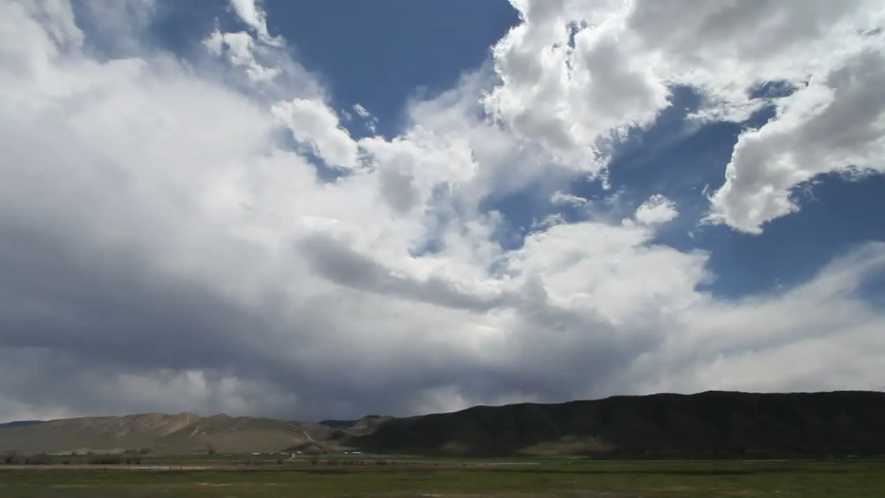 Dramatic clouds move across low hills