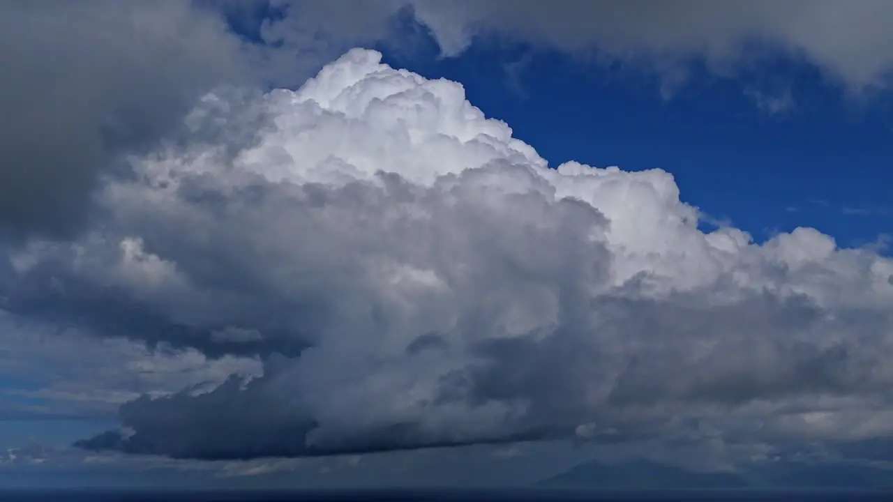 Dense clouds moving through the blue sky during the day