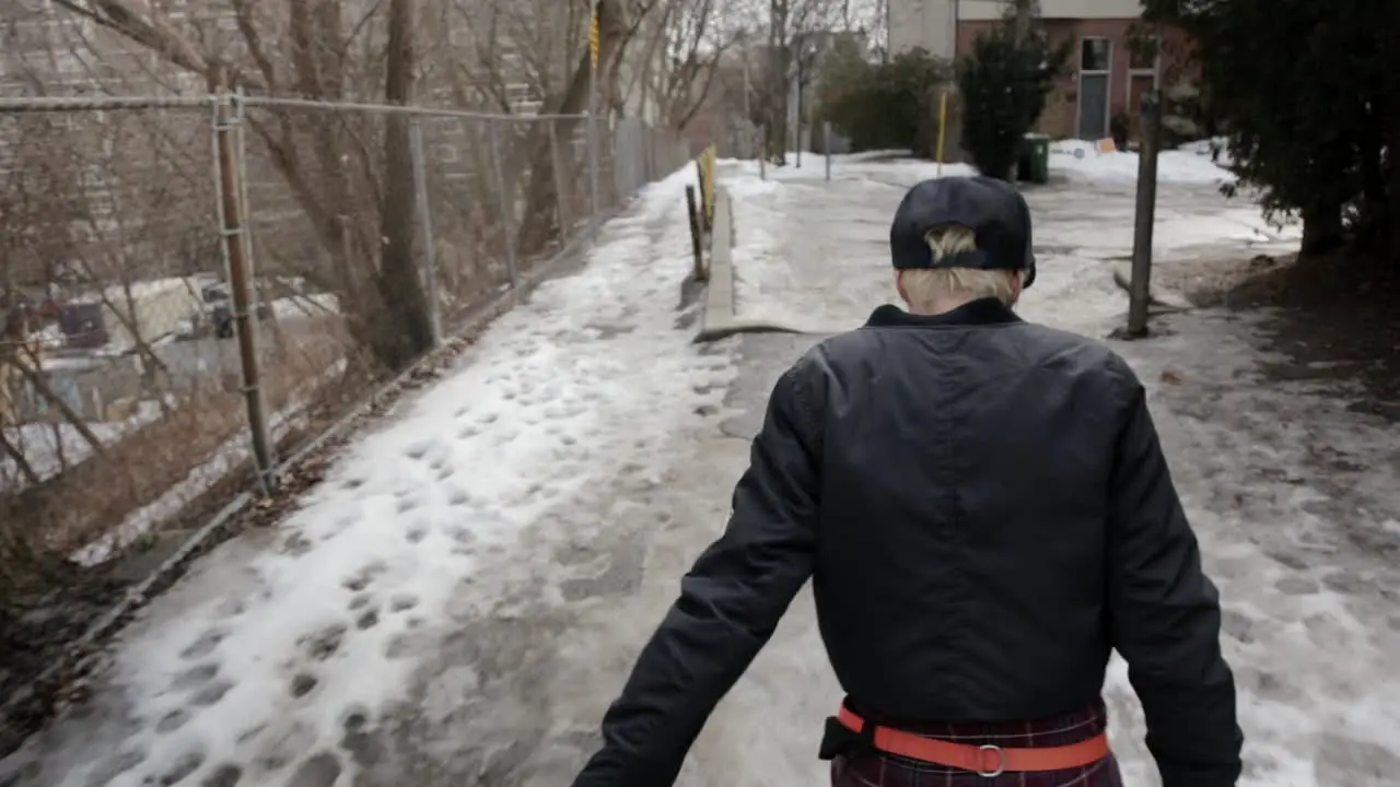 Tracking shot from behind a person slipping and sliding on ice