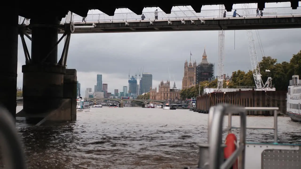 View of London city under the Tower Bridge from a boat on the Thames