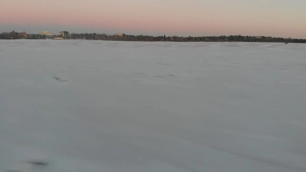 showing snow on a frozen lake