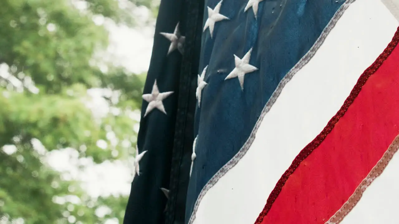 American flag waving in slow motion with rain