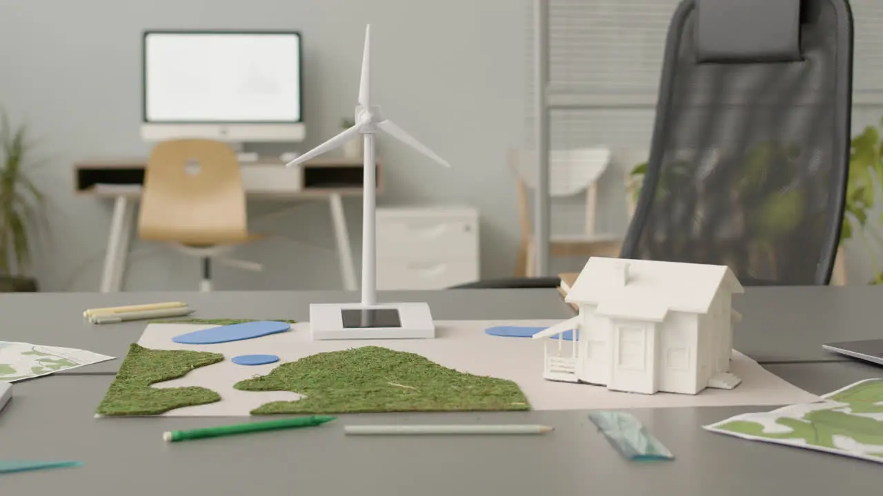 Wind Turbine Miniature And House Model On Office Table