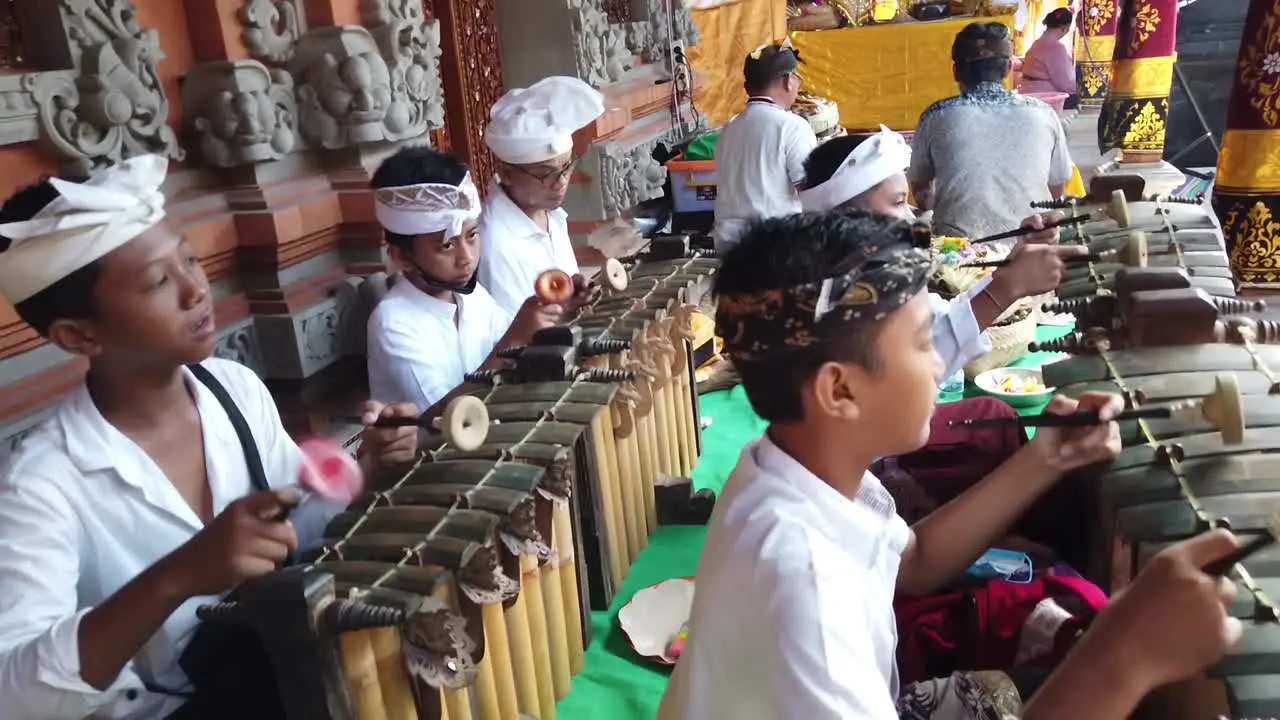 Children Play Gamelan Music Balinese Traditional Orchestra at Bali Temple Stage Hindu Religious Ceremony in White Clothes Indonesia Southeast Asia