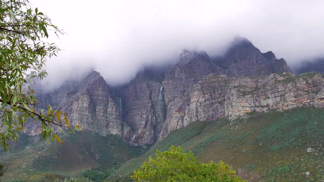 Multiple small waterfalls on mountain side after heavy rains Du Toit's Kloof South Africa wide-angle shot