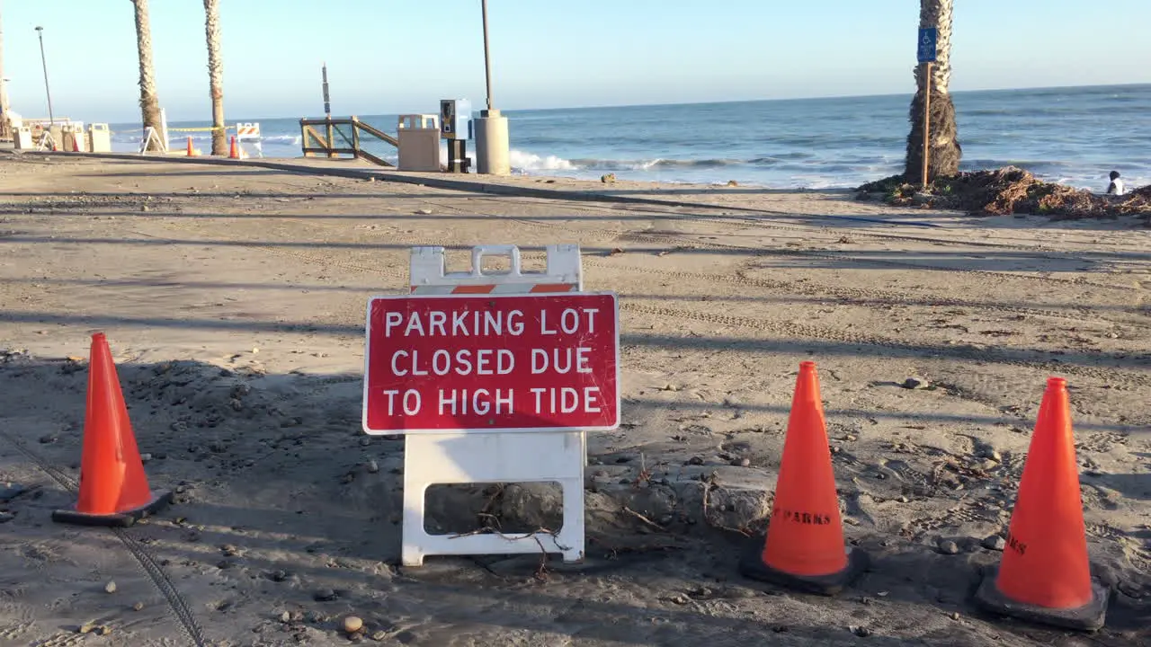 Beach side parking lot full of mud and orange cones