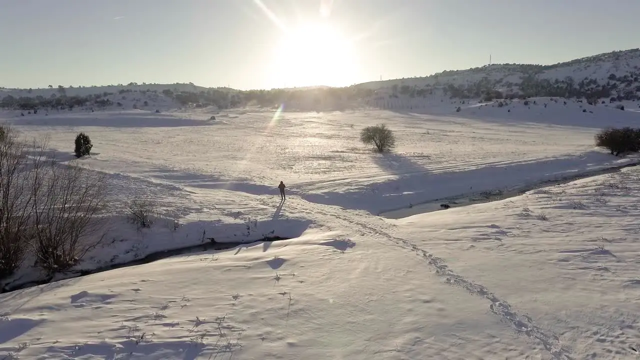 A Man Standing on Snowy Fields Drone Footage