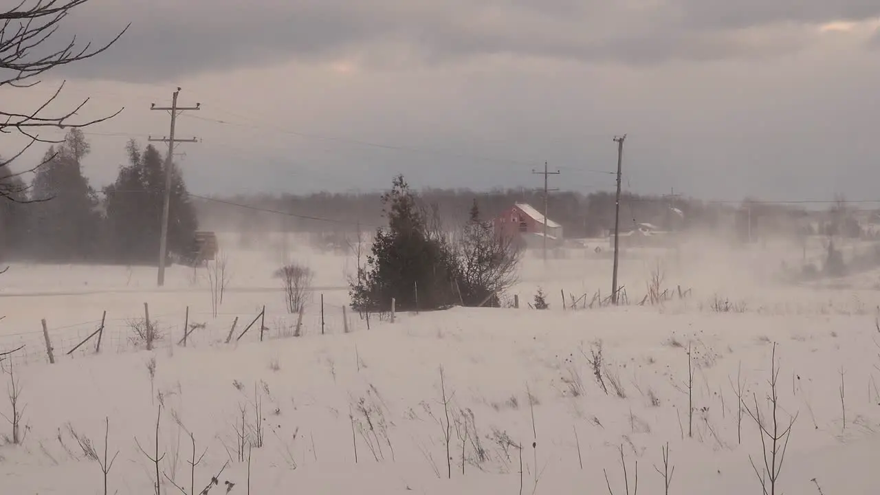 static shot of an empty road during a heavy snowstorm with heavy winds