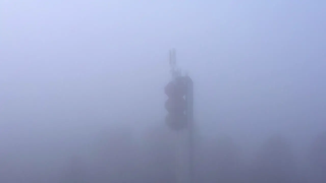 Telecommunication tower in thick fog signal trasmitting in bad weather conditions