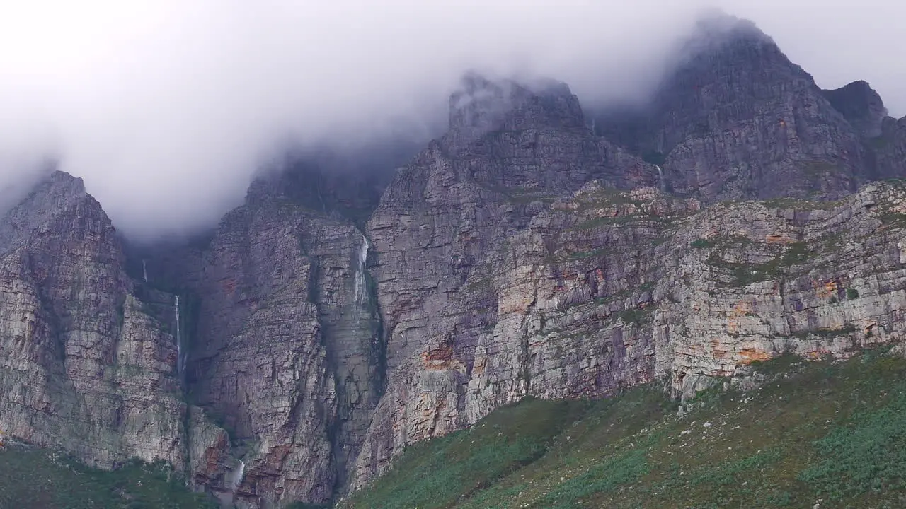 Multiple small waterfalls falling down mountainside after heavy rains Du Toit's Kloof South Africa zoomed-in shot