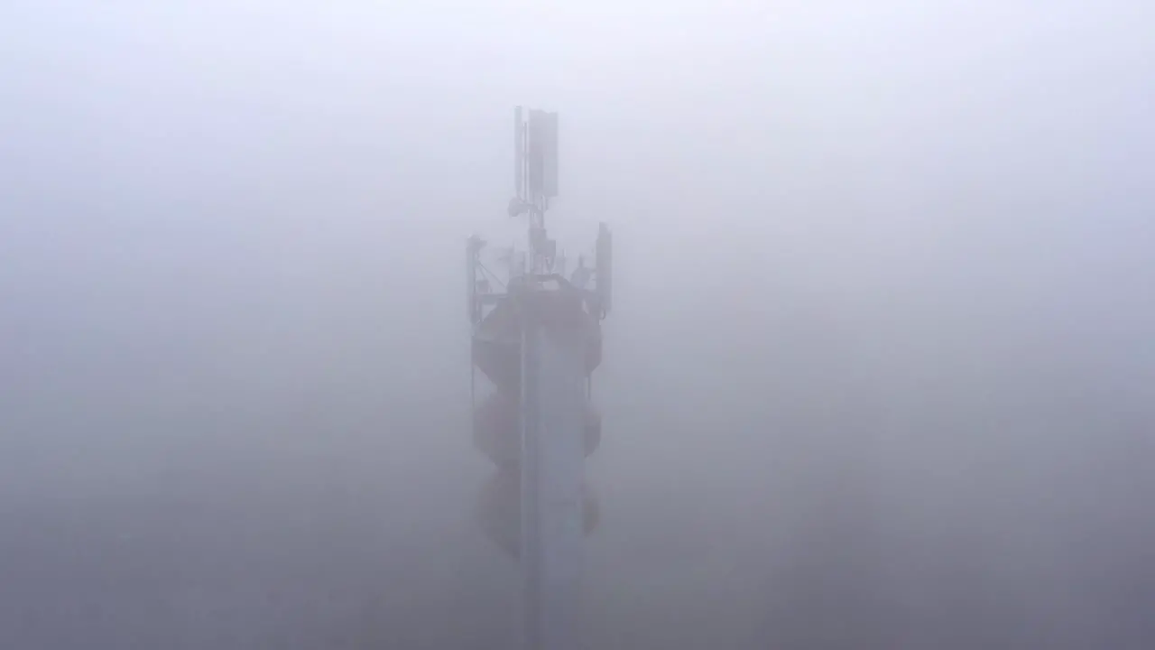 Mobile network antennas on a water tower transmitting in bad weather aerial view