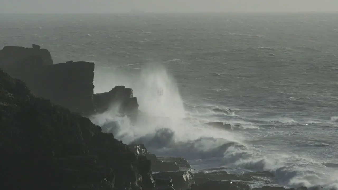 Stunning cinematic shot of big waves battering the cornish coast