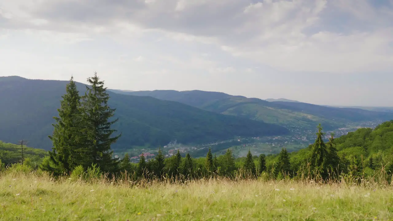 A Young Couple Is Happy To Come To A Resting Place In The Mountains Strike Their Hands Hug Rush Into