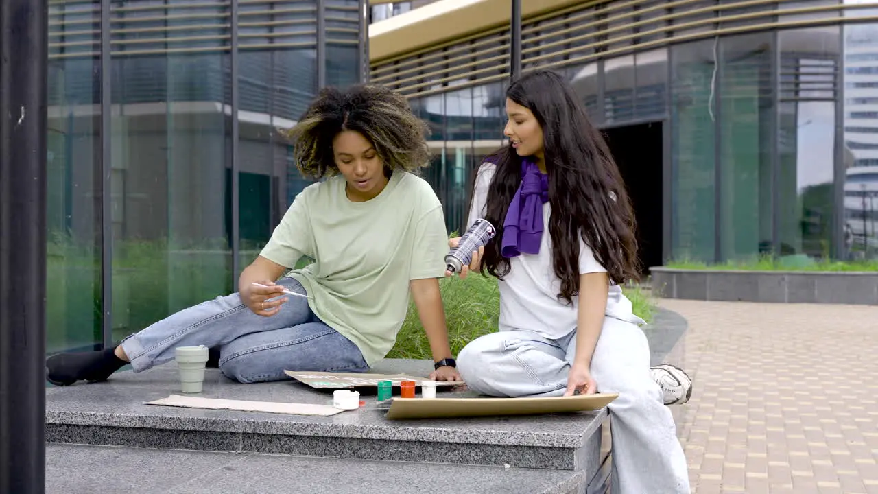 Woman And Woman Painting Placards For The Environment Protest