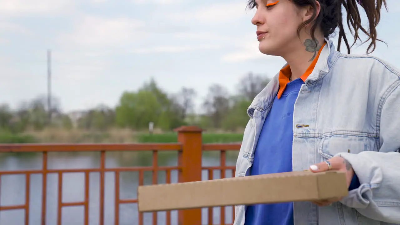 Two Girl Friends Drinking Beer And Walking On A Bridge While Talking Between Them