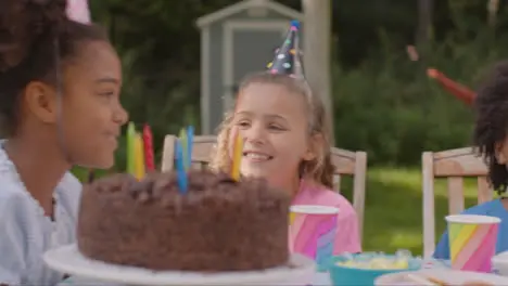 Tracking Shot of Children Sitting at Table at Outdoor Birthday Party 11