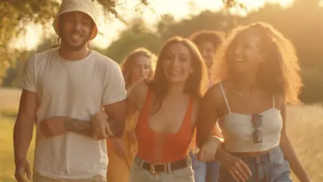 Tracking Shot of Group of Friends Walking at Sunset