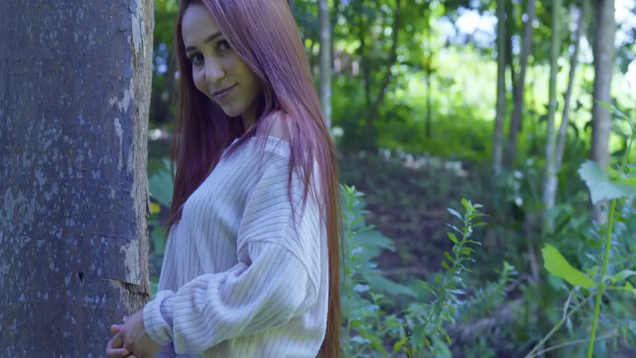 Close up descending view of a red hair girl in a forested park on a tropical island