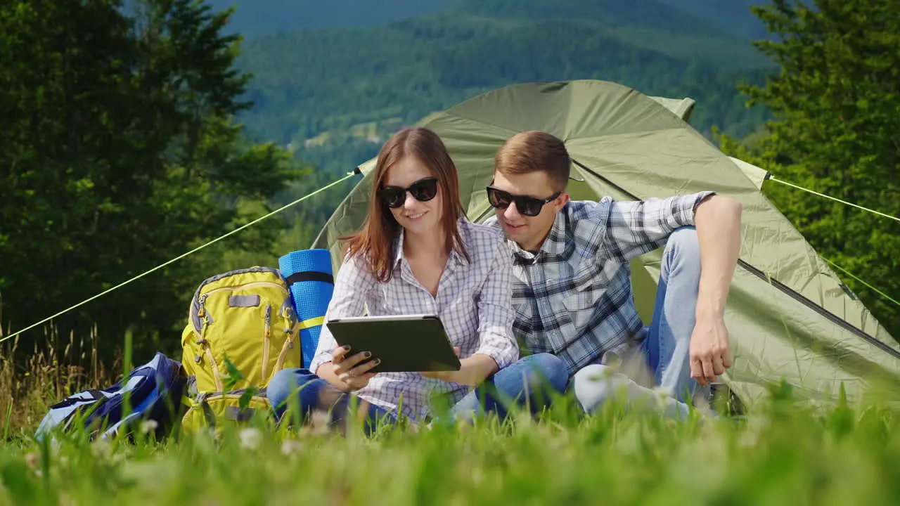 Young People Are Resting In The Campsite And They Use Laptops 2