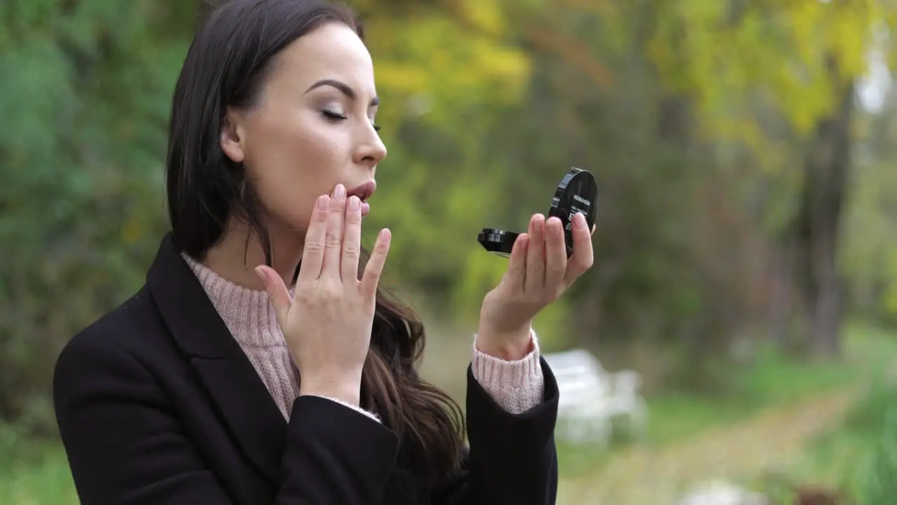 Woman looking at pocket mirror