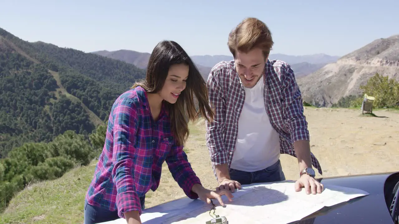 Couple investigating map during mountain trip