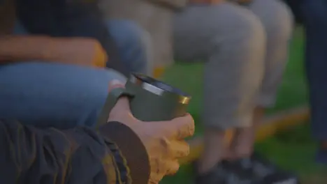 Close Up Shot of Senior Man's Hand Holding Travel Mug