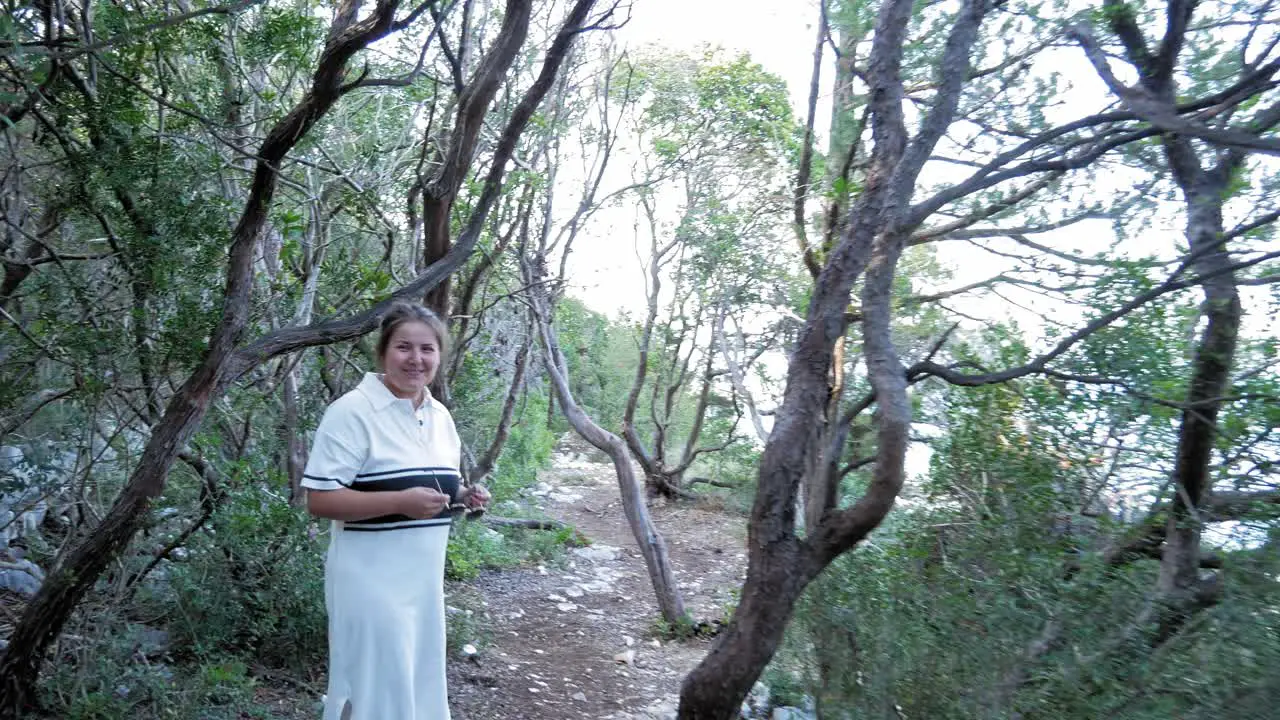 Tourist Woman Walking On Forest Landscape handheld shot