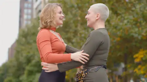 Low Angle Shot of Two Female Friends Hugging Each Other