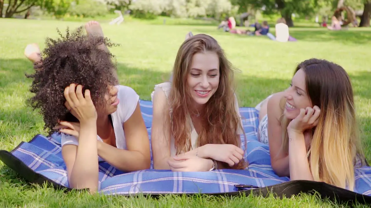 Happy women lying on meadow