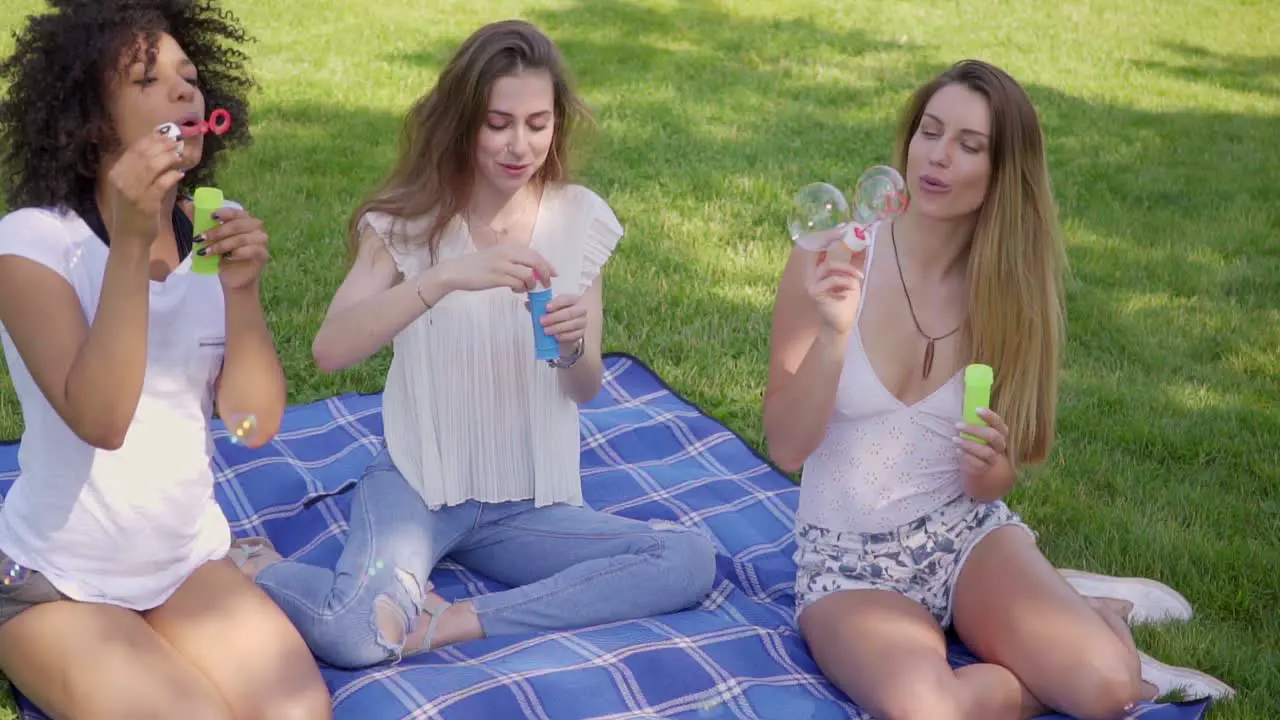 Young women blowing bubbles