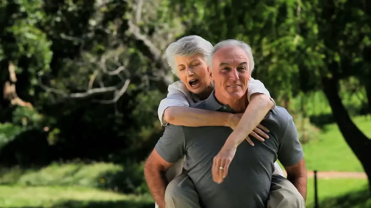 Old man carrying his wife