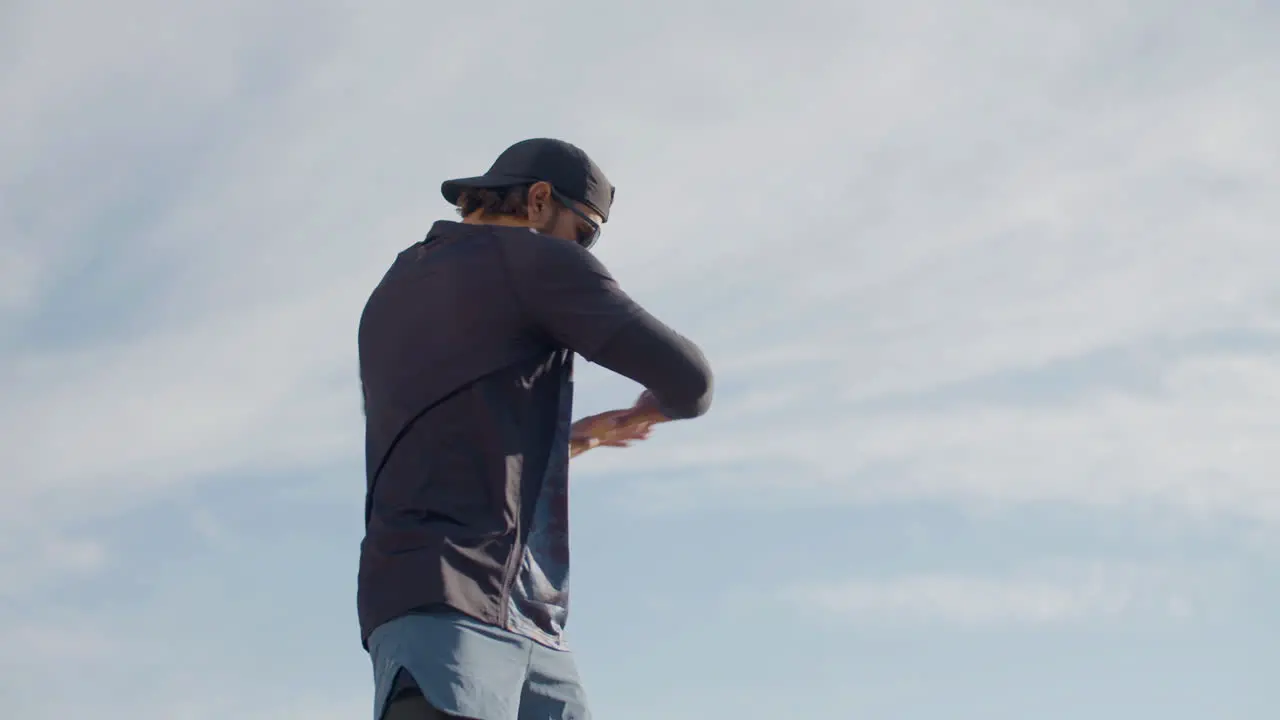 Medium Shot Of A Focused Sportsman Warming Up And Doing Curls Before Outdoor Workout