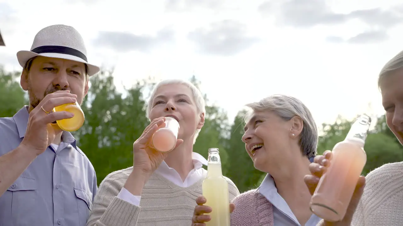 Group Of Senior People Dancing Toasting With A Bottle And Laughing