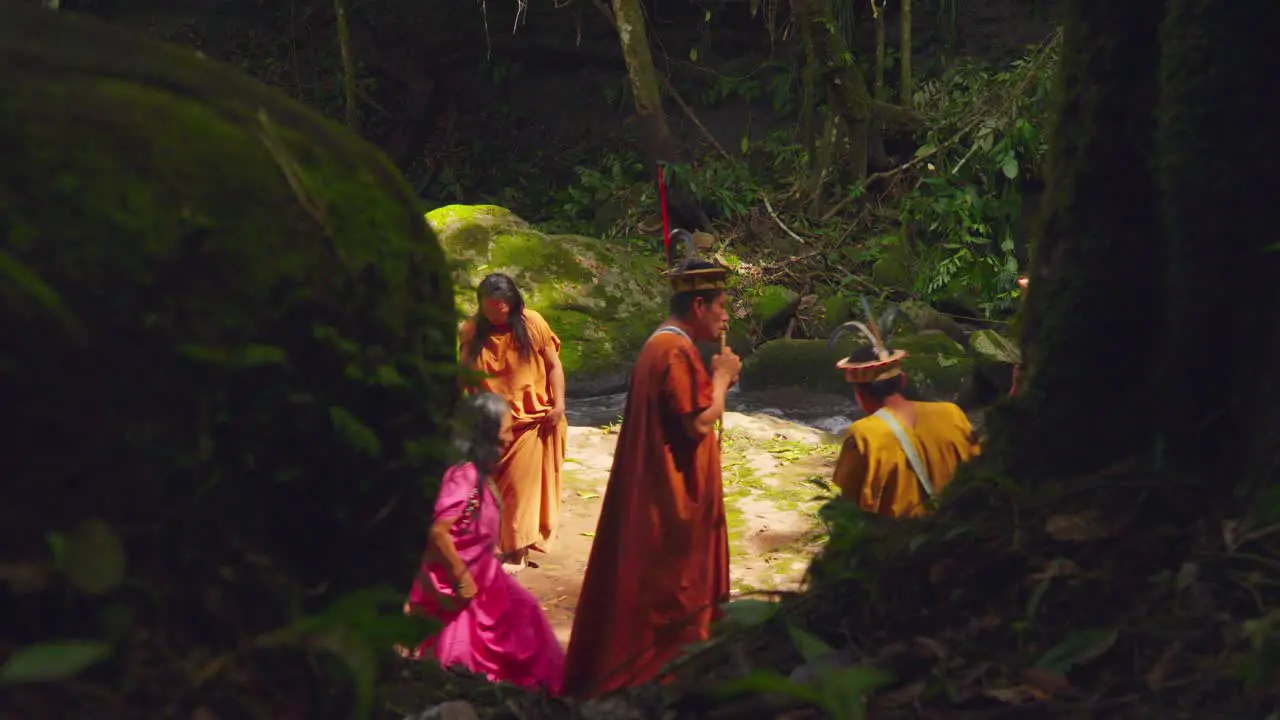 Indigenous people in traditional attire in Pucallpa Peru engaging in a cultural ceremony in the forest