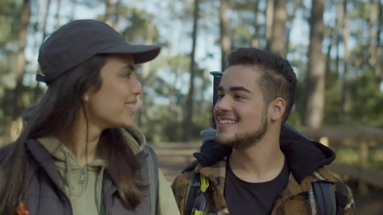 Young Couple Walking In Forest And Kissing