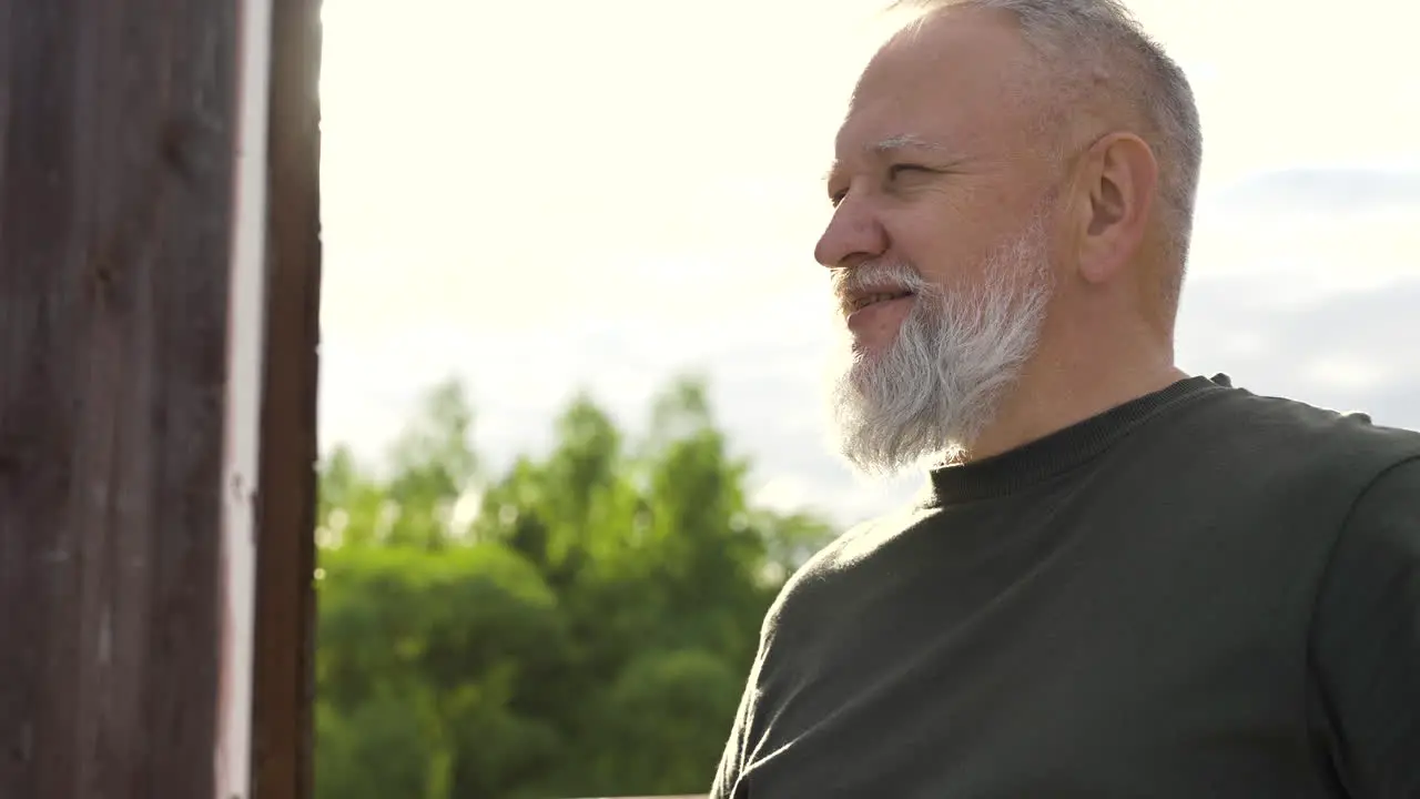 A Bearded Man Having A Drink Outdoors