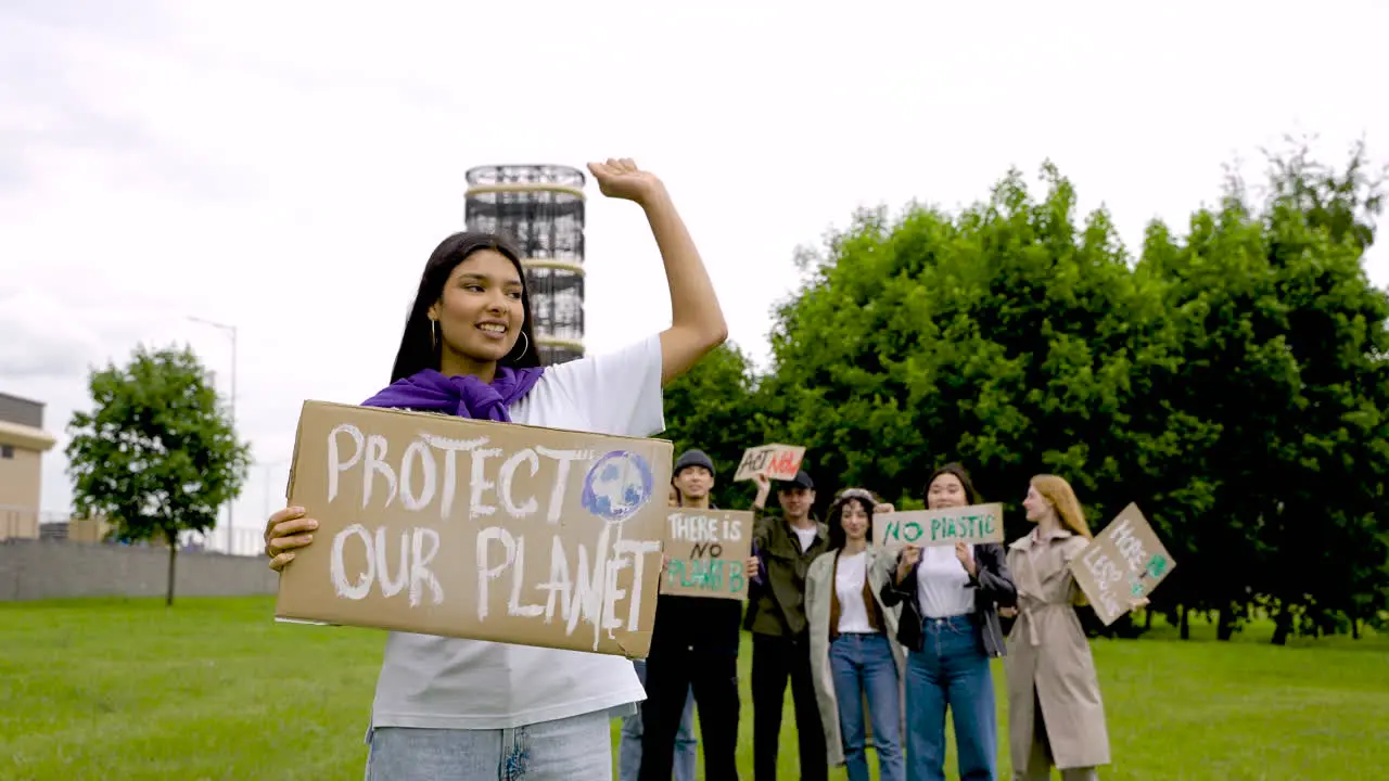 Close Up Of A Girl Holding A Placard And Talking