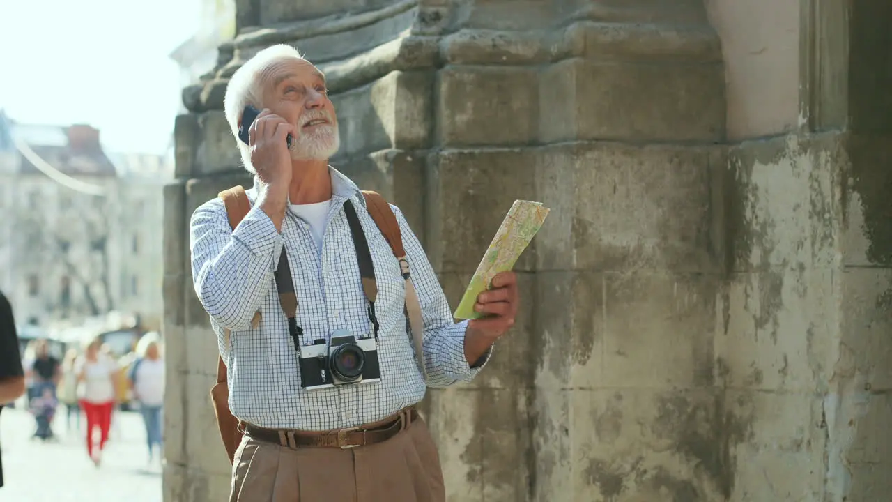 Senior Tourist With Photocamera And Map