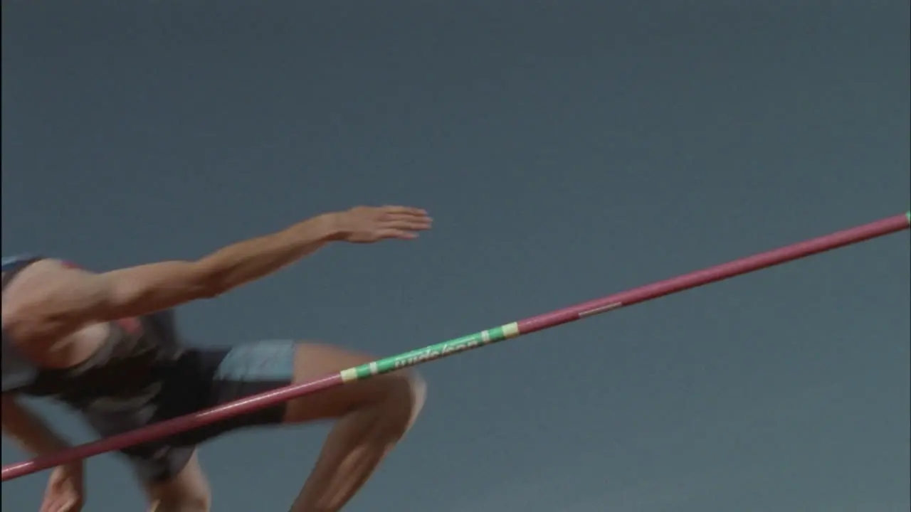 A man completes a high jump