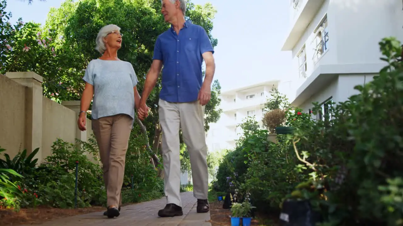 Senior couple walking in the garden