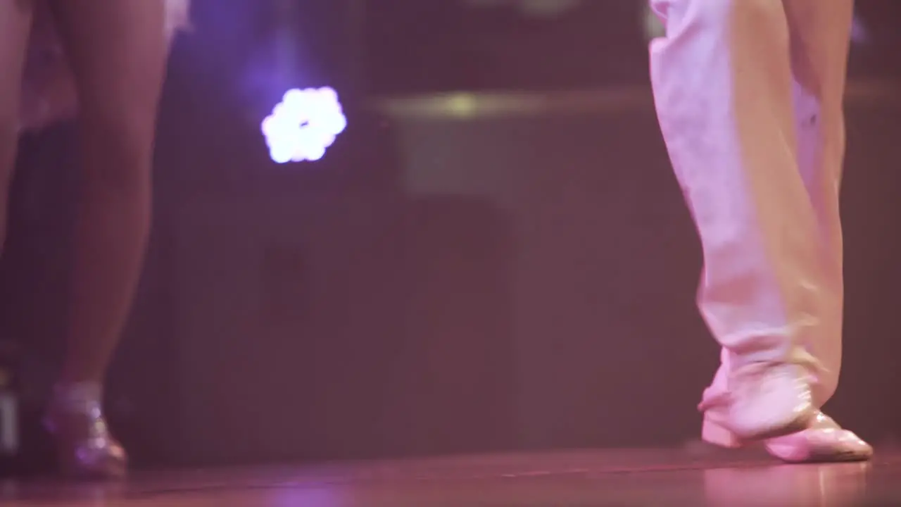 close up of couple of dancer's dancing at a show with white costumes and shiny shoes  lifestyle cuban salsa dance