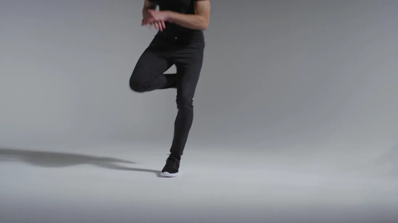 Long Shot of Man's Legs Breakdancing