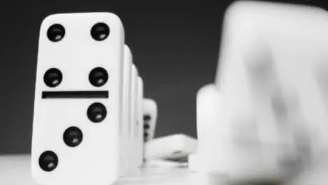 Close Up of Two Lines of Dominoes Falling