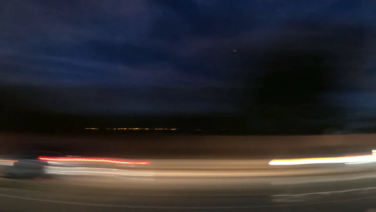 Driving through the city under the blue night sky time lapse