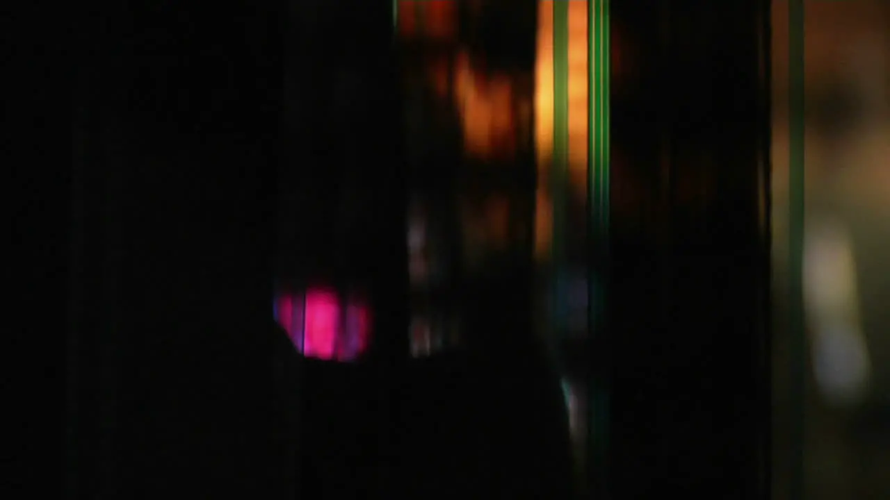 A backlit strip of film runs through a projector