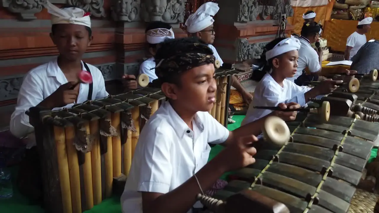 Balinese Children Play Gamelan Traditional Religious Music at Temple Ceremony Bali Indonesia Cultural Ancient Art