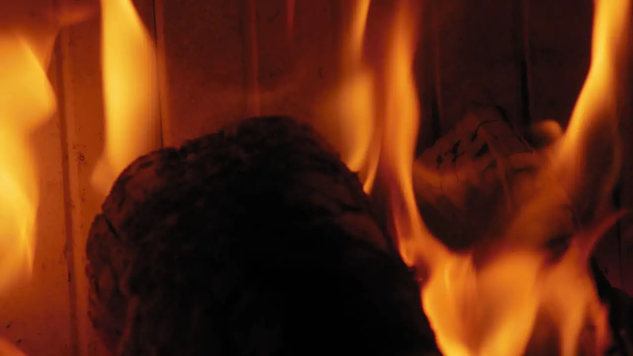 Burning Flame At Fireplace on wooden logs