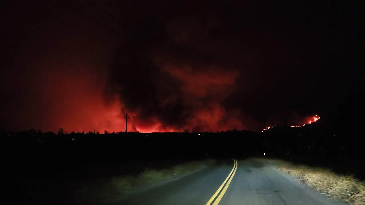 First person view of a hill fire from the car passing on the road