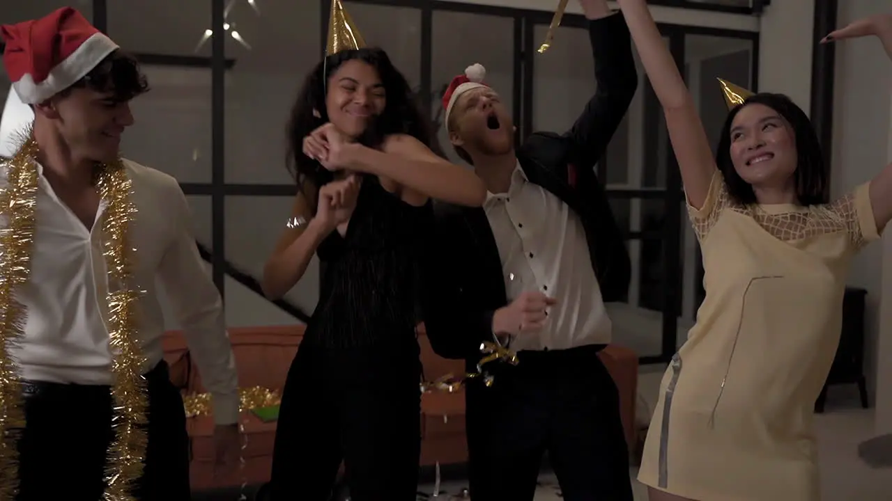 Female And Male Happy Friends Dancing With Confetti And Celebrating A Party At Home