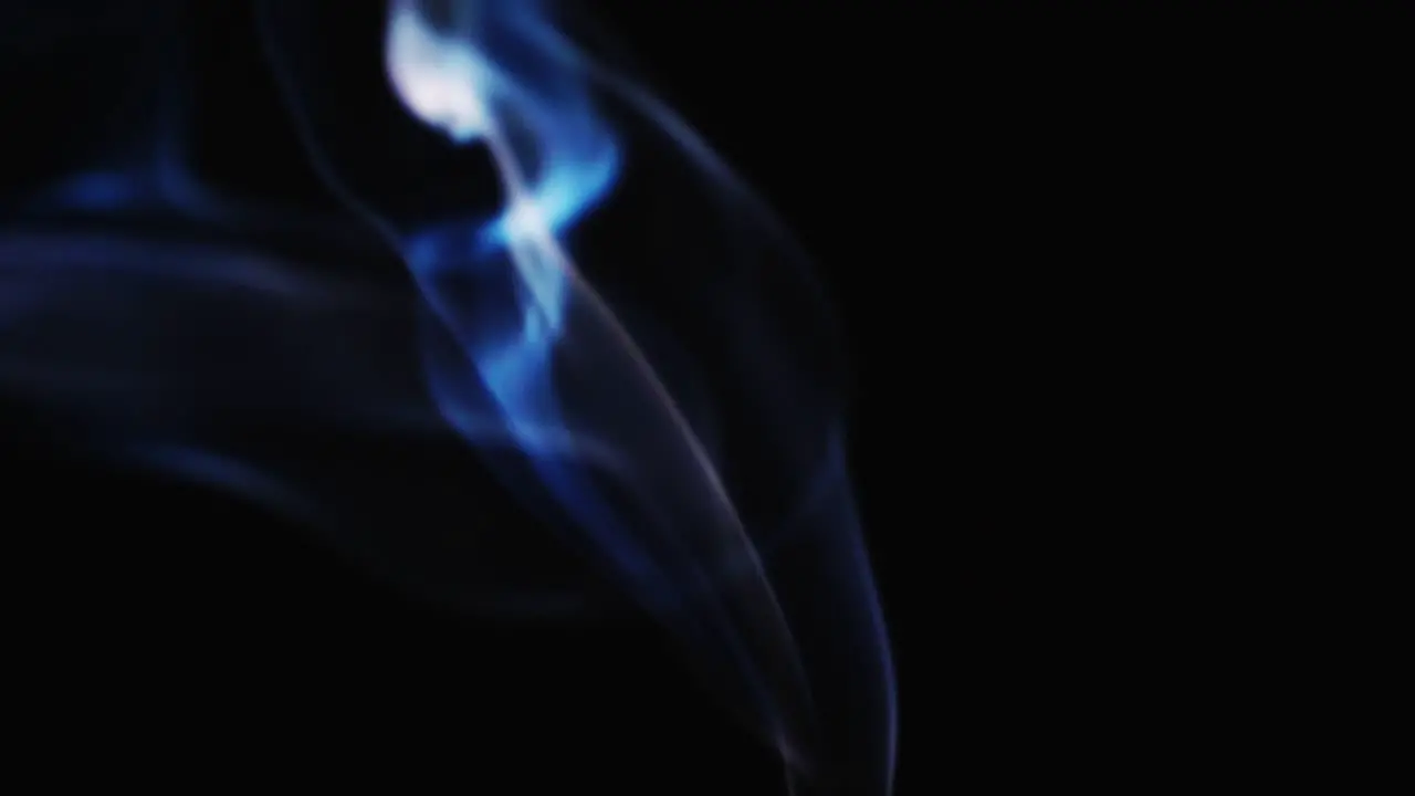 Abstract blue color smoke with a black background in slow motion